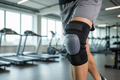 Silicone knee strap with adjustable patella support worn during athletic activity